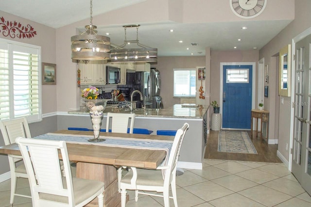 1115 San Cristobal Ave, Punta Gorda, FL 33983 - dining area with light tile patterned floors, recessed lighting, and lofted ceiling