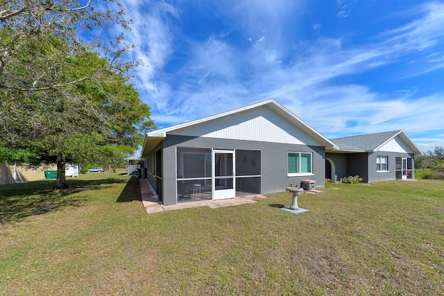 1115 San Cristobal Ave, Punta Gorda, FL 33983 - rear view of house featuring a sunroom and a lawn