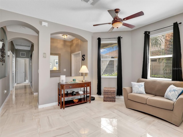 4180 Lenox Blvd, Venice, FL 34293 - living room featuring ceiling fan, arched walkways, and light marble finish floors
