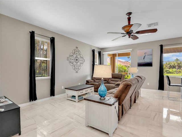 4180 Lenox Blvd, Venice, FL 34293 - living room with ceiling fan and light marble finish flooring