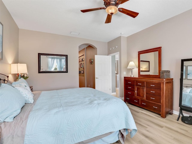 4180 Lenox Blvd, Venice, FL 34293 - bedroom featuring arched walkways, light wood-style floors, and ceiling fan