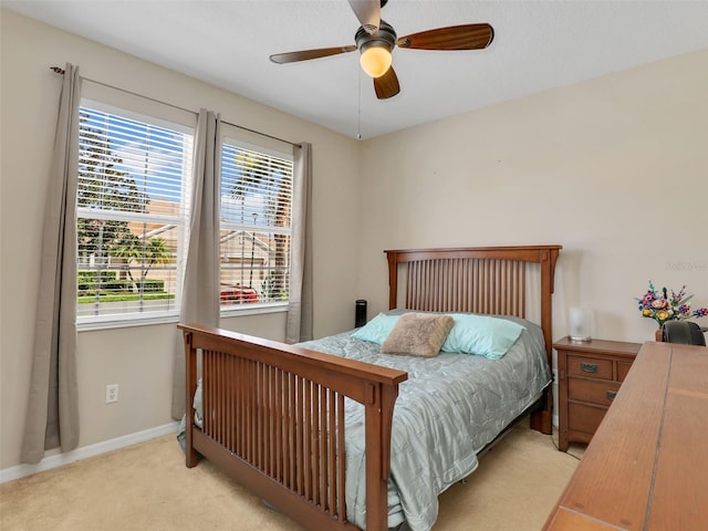 4180 Lenox Blvd, Venice, FL 34293 - bedroom featuring multiple windows, light colored carpet, and a ceiling fan