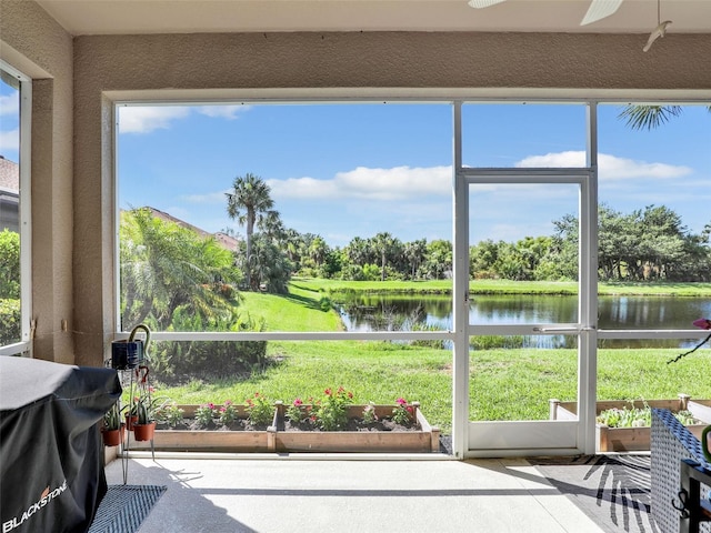 4180 Lenox Blvd, Venice, FL 34293 - sunroom featuring a water view, ceiling fan, and view of scattered trees