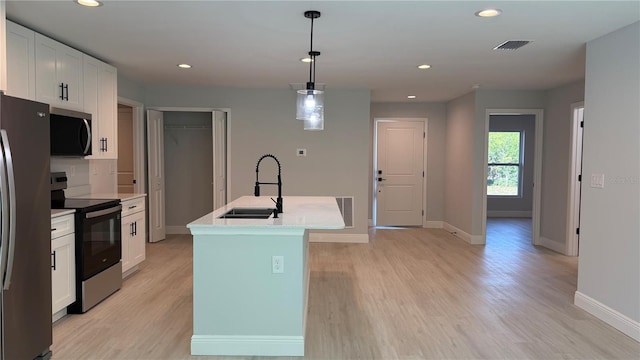7052 Legion St, Port Charlotte, FL 33981 - kitchen with appliances with stainless steel finishes, white cabinetry, light wood-type flooring, light countertops, and recessed lighting