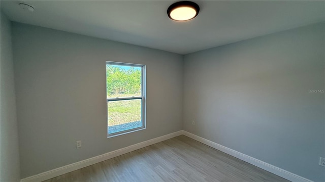 7052 Legion St, Port Charlotte, FL 33981 - empty room with light wood-style floors and baseboards