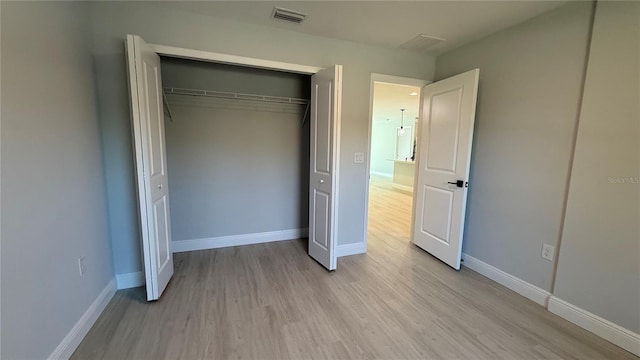 7052 Legion St, Port Charlotte, FL 33981 - unfurnished bedroom with light wood-style flooring and a closet