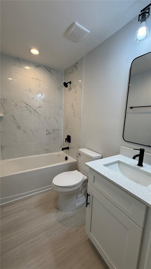 7052 Legion St, Port Charlotte, FL 33981 - bathroom with vanity, washtub / shower combination, wood finished floors, and recessed lighting
