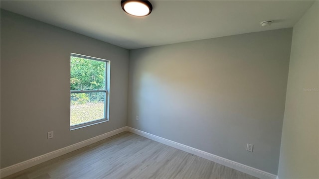 7052 Legion St, Port Charlotte, FL 33981 - spare room with light wood finished floors and a smoke detector