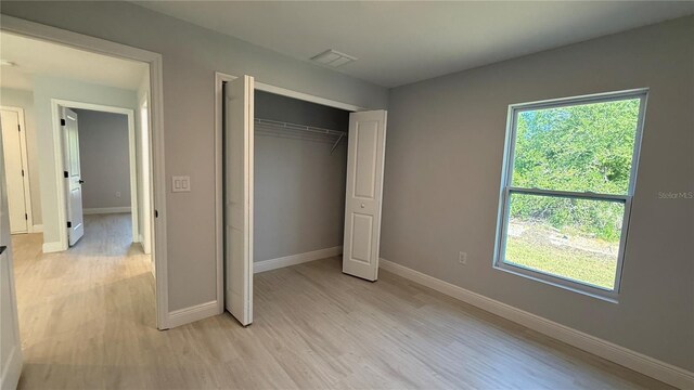 7052 Legion St, Port Charlotte, FL 33981 - unfurnished bedroom with light wood-style flooring and a closet