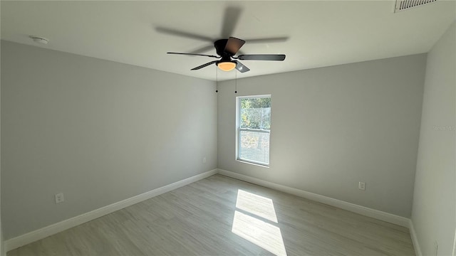 7052 Legion St, Port Charlotte, FL 33981 - empty room with light wood-style floors, a ceiling fan, and a smoke detector