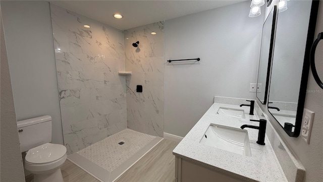 7052 Legion St, Port Charlotte, FL 33981 - full bathroom with double vanity, a marble finish shower, recessed lighting, and wood finished floors