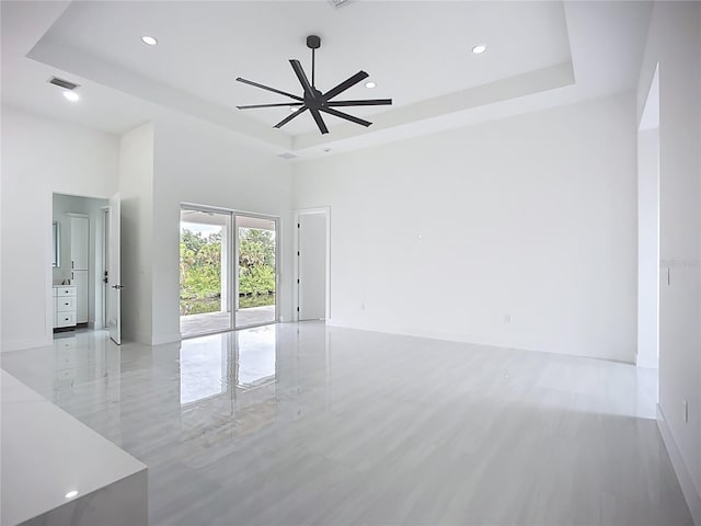 576 Mcdill Dr, Port Charlotte, FL 33953 - spare room with a tray ceiling, a ceiling fan, a high ceiling, and recessed lighting