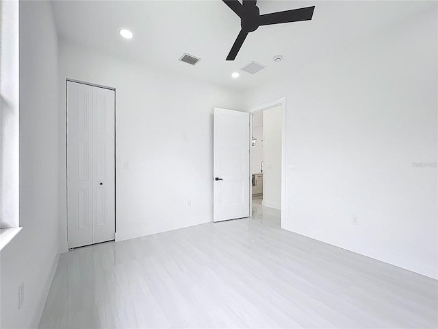 576 Mcdill Dr, Port Charlotte, FL 33953 - unfurnished bedroom featuring a closet, recessed lighting, ceiling fan, and light wood-style floors
