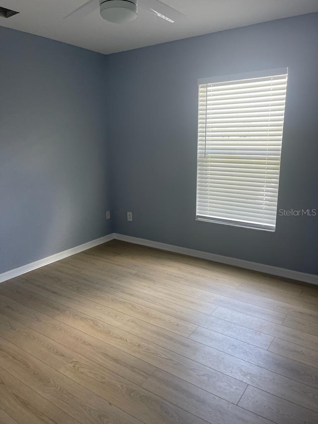 1708 Blue Lake Cir, Punta Gorda, FL 33983 - empty room with wood finished floors and ceiling fan