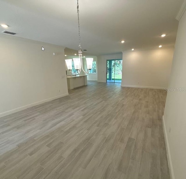 41 Fountain Gate Ln, Palm Coast, FL 32137 - spare room with a chandelier, light wood-type flooring, and recessed lighting