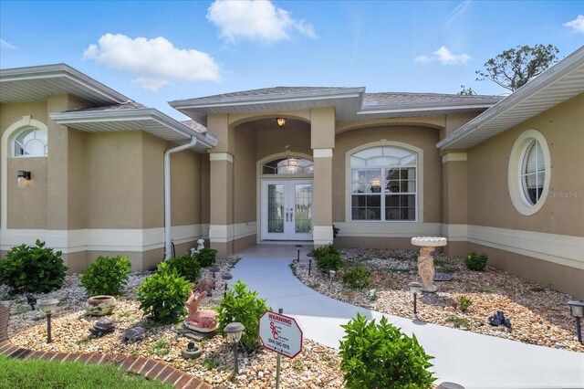 2329 Como St, Port Charlotte, FL 33948 - entrance to property with french doors, stucco siding, and a shingled roof