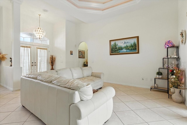 2329 Como St, Port Charlotte, FL 33948 - living area featuring crown molding, light tile patterned floors, arched walkways, a chandelier, and french doors