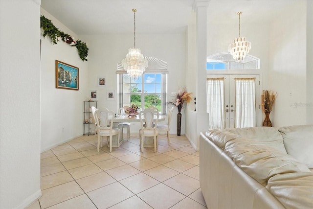 2329 Como St, Port Charlotte, FL 33948 - dining area with a chandelier, light tile patterned floors, french doors, and a towering ceiling