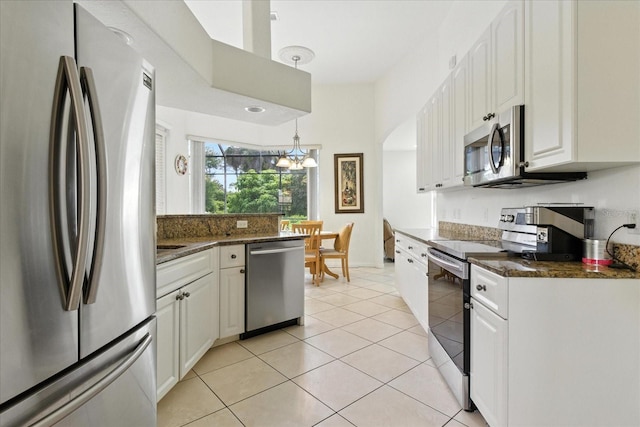 2329 Como St, Port Charlotte, FL 33948 - kitchen featuring appliances with stainless steel finishes, a chandelier, light tile patterned floors, and white cabinets