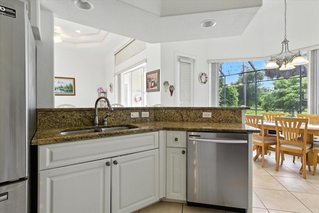 2329 Como St, Port Charlotte, FL 33948 - kitchen featuring stainless steel appliances, white cabinetry, light tile patterned floors, dark stone counters, and crown molding