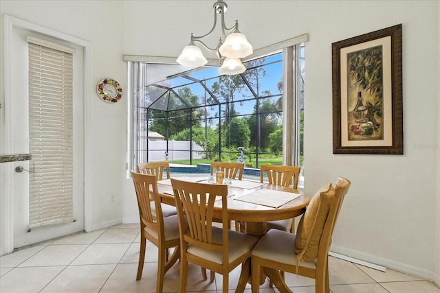 2329 Como St, Port Charlotte, FL 33948 - dining room with light tile patterned floors, a sunroom, and a chandelier