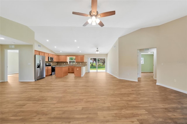 3993 NE Bobay Rd, Arcadia, FL 34266 - kitchen featuring stainless steel appliances, open floor plan, vaulted ceiling, ceiling fan, and light wood-type flooring
