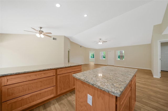 3993 NE Bobay Rd, Arcadia, FL 34266 - kitchen with ceiling fan, lofted ceiling, light wood-style floors, light stone counters, and recessed lighting