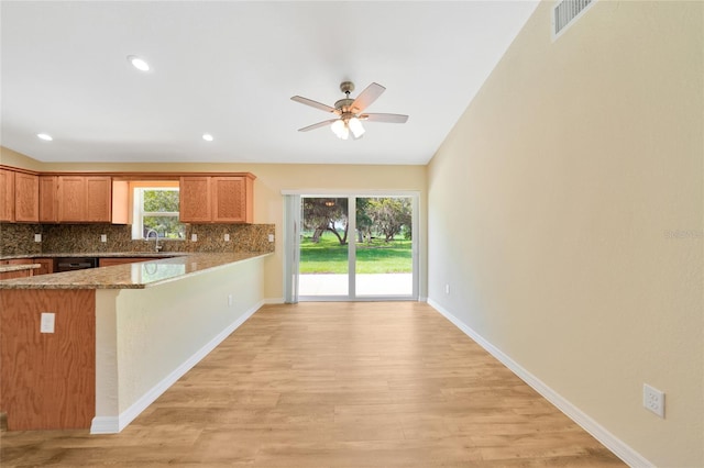 3993 NE Bobay Rd, Arcadia, FL 34266 - kitchen featuring light wood-type flooring, a ceiling fan, decorative backsplash, a peninsula, and recessed lighting