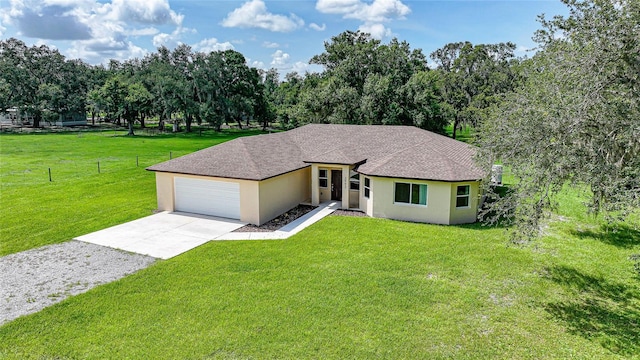 3993 NE Bobay Rd, Arcadia, FL 34266 - view of front of house with stucco siding, concrete driveway, a garage, and a shingled roof