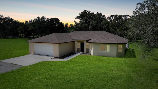 3993 NE Bobay Rd, Arcadia, FL 34266 - view of front facade featuring concrete driveway, stucco siding, a front lawn, and roof with shingles