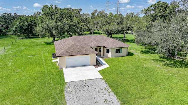 3993 NE Bobay Rd, Arcadia, FL 34266 - single story home featuring stucco siding, concrete driveway, view of wooded area, an attached garage, and roof with shingles