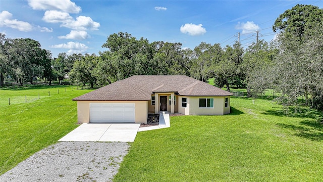 3993 NE Bobay Rd, Arcadia, FL 34266 - ranch-style house featuring stucco siding, driveway, view of wooded area, an attached garage, and roof with shingles