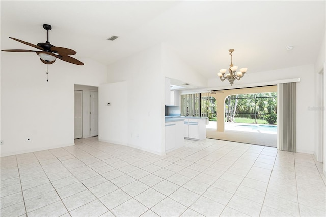 18147 Brazil Ave, Port Charlotte, FL 33948 - unfurnished living room with a chandelier, light tile patterned floors, high vaulted ceiling, and ceiling fan