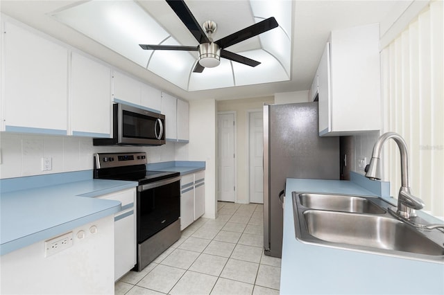 18147 Brazil Ave, Port Charlotte, FL 33948 - kitchen with stainless steel appliances, ceiling fan, light tile patterned floors, white cabinetry, and light countertops