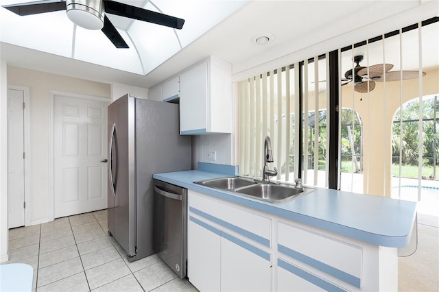 18147 Brazil Ave, Port Charlotte, FL 33948 - kitchen with a ceiling fan, stainless steel dishwasher, white cabinetry, and light tile patterned flooring