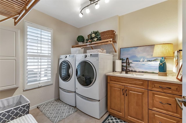 1250 W Marion Ave Unit 333, Punta Gorda, FL 33950 - washroom featuring washing machine and clothes dryer, light tile patterned flooring, and cabinet space