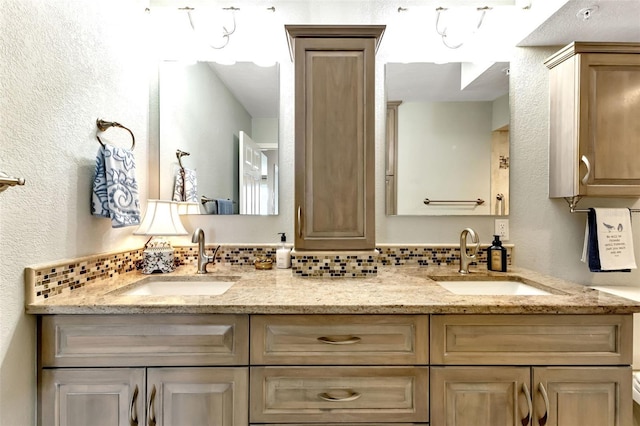 1250 W Marion Ave Unit 333, Punta Gorda, FL 33950 - full bath with double vanity, a textured wall, and decorative backsplash