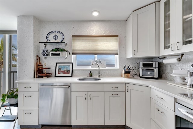 1250 W Marion Ave Unit 333, Punta Gorda, FL 33950 - kitchen featuring appliances with stainless steel finishes, healthy amount of natural light, decorative backsplash, and white cabinets