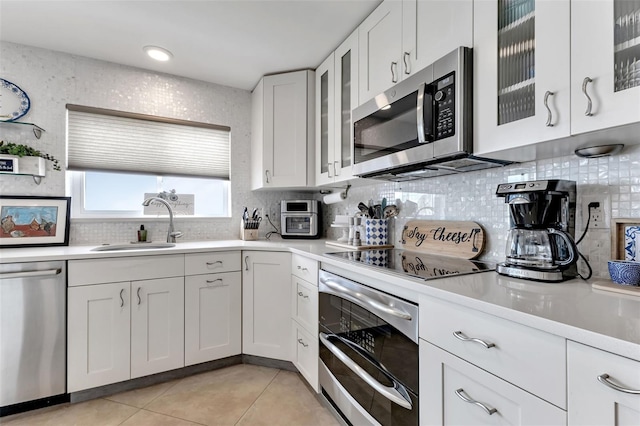 1250 W Marion Ave Unit 333, Punta Gorda, FL 33950 - kitchen featuring stainless steel appliances, tasteful backsplash, light countertops, and white cabinetry