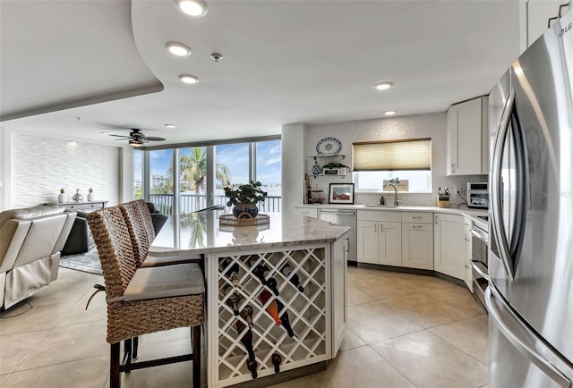 1250 W Marion Ave Unit 333, Punta Gorda, FL 33950 - kitchen with stainless steel appliances, open floor plan, light tile patterned flooring, plenty of natural light, and recessed lighting