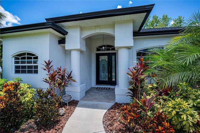 3824 Dominic St, North Port, FL 34288 - view of exterior entry with stucco siding and a garage