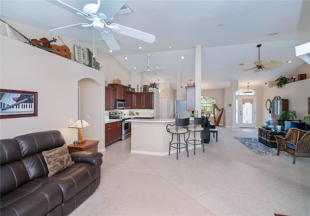 3824 Dominic St, North Port, FL 34288 - living room featuring ceiling fan, light tile patterned floors, high vaulted ceiling, and recessed lighting