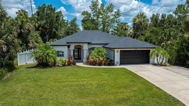 3824 Dominic St, North Port, FL 34288 - view of front of property with driveway, a garage, a shingled roof, and stucco siding