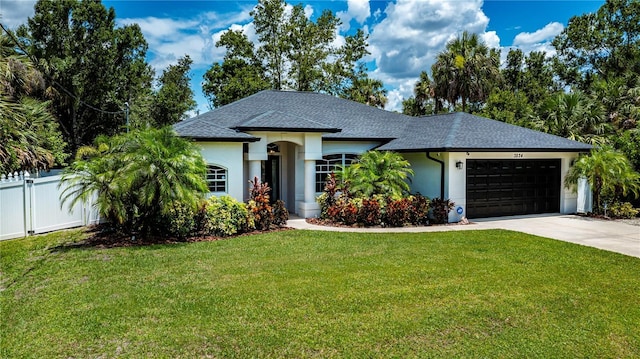 3824 Dominic St, North Port, FL 34288 - view of front of property featuring a shingled roof, stucco siding, an attached garage, and driveway