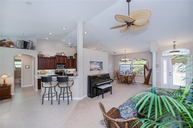 3824 Dominic St, North Port, FL 34288 - kitchen featuring stainless steel appliances, a ceiling fan, a kitchen breakfast bar, arched walkways, and high vaulted ceiling