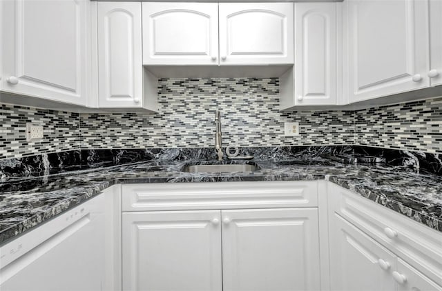 2437 Harbor Blvd Unit 114, Port Charlotte, FL 33952 - kitchen featuring white dishwasher, white cabinets, tasteful backsplash, and dark stone countertops