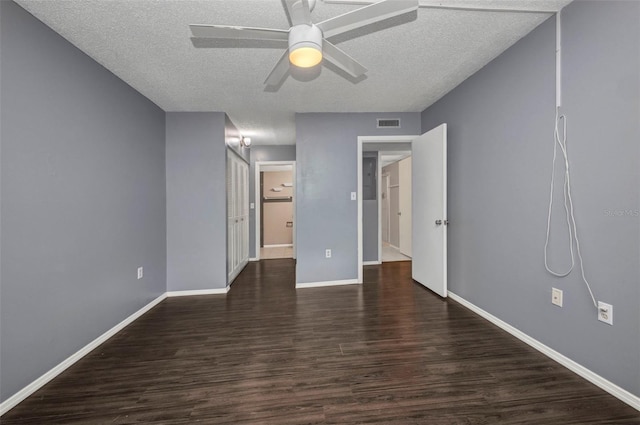 2437 Harbor Blvd Unit 114, Port Charlotte, FL 33952 - unfurnished bedroom with dark wood-style flooring, a textured ceiling, and ceiling fan