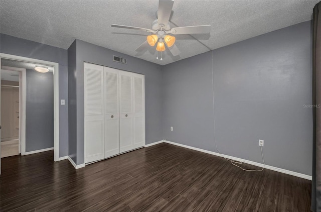 2437 Harbor Blvd Unit 114, Port Charlotte, FL 33952 - unfurnished bedroom with wood finished floors, a closet, a textured ceiling, and ceiling fan