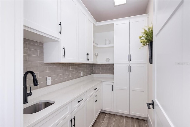 3800 Carupano Ct, Punta Gorda, FL 33950 - kitchen with open shelves, white cabinets, and backsplash