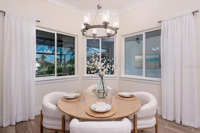 3800 Carupano Ct, Punta Gorda, FL 33950 - dining room featuring a chandelier, wood finished floors, and crown molding